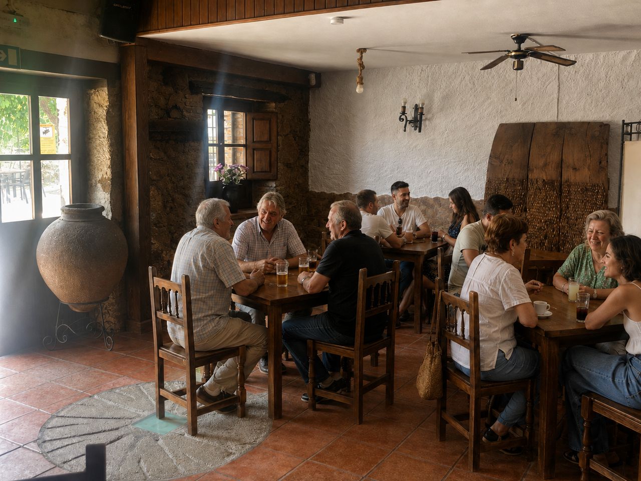 Full tables in the stone dining room, beers and coffees on the wood, the clay tinaja behind and the millstone set into the floor